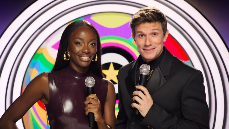 a man and a woman standing next to each other holding microphones