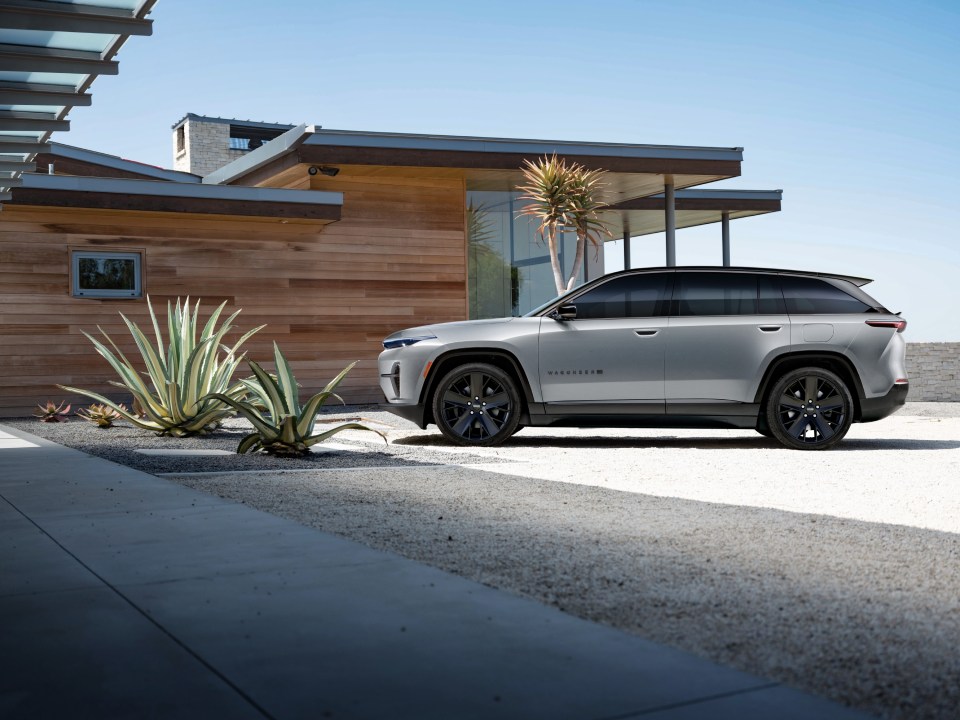 a silver harrier is parked in front of a house