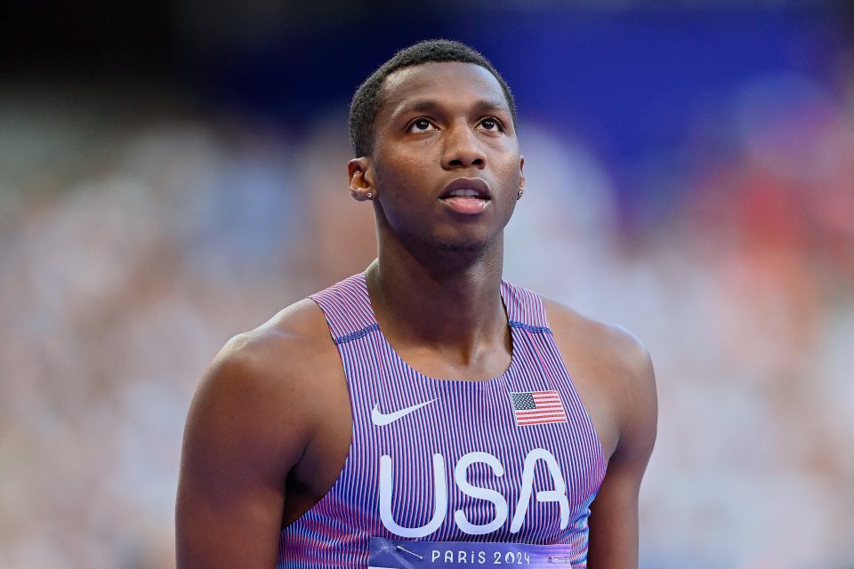 a man wearing a usa tank top looks up
