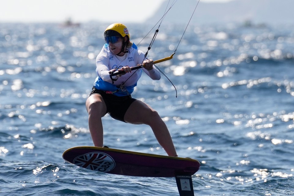 a woman is riding a foil board in the ocean