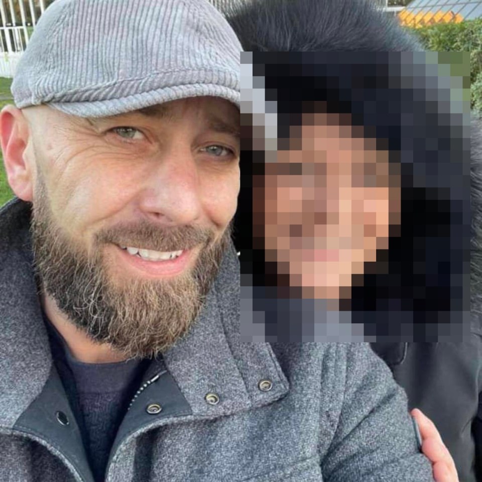 a man with a beard is posing for a picture with a woman