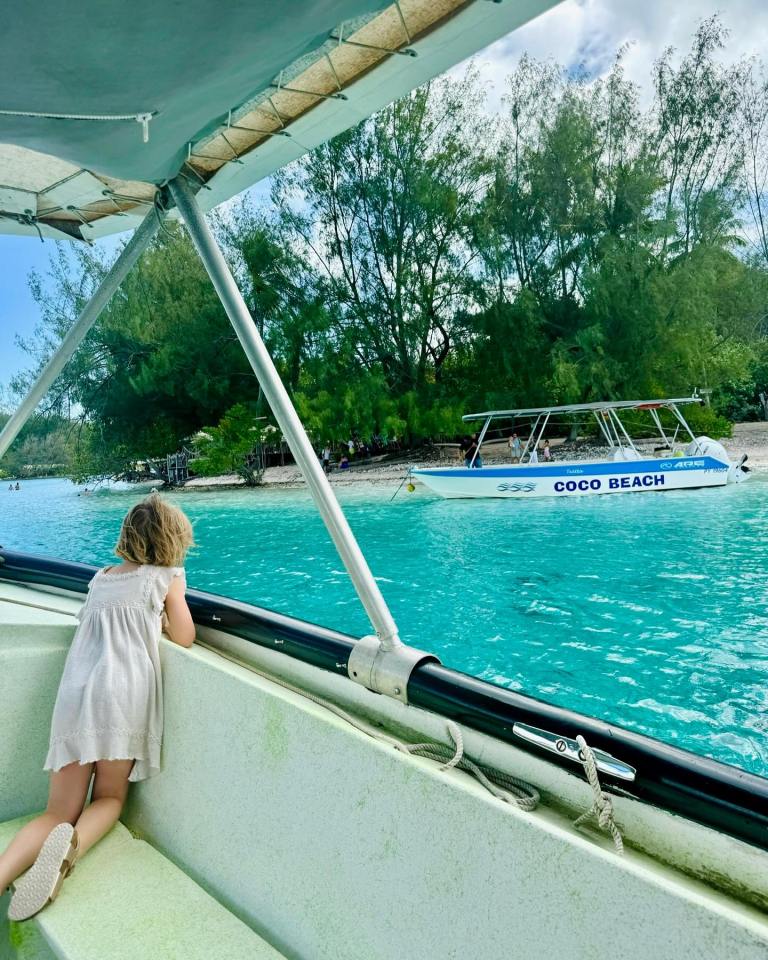 a little girl on a boat that says coco beach