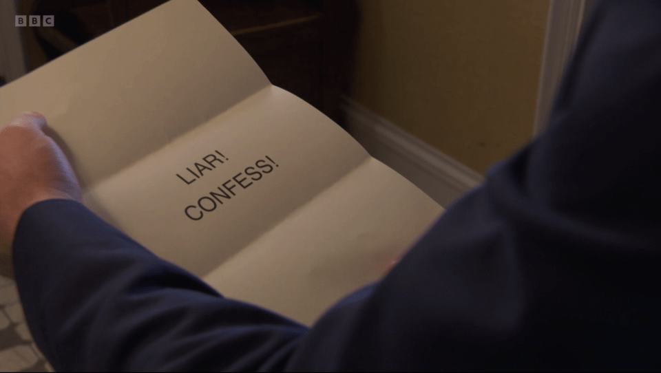 a man is holding a piece of paper that says liar confess