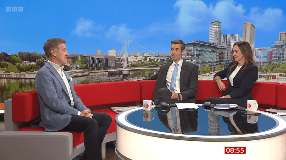 three people sit around a table with a bbc logo on the bottom right