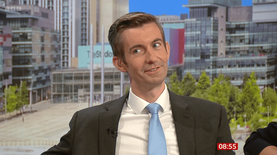 a man in a suit and tie is on a bbc show