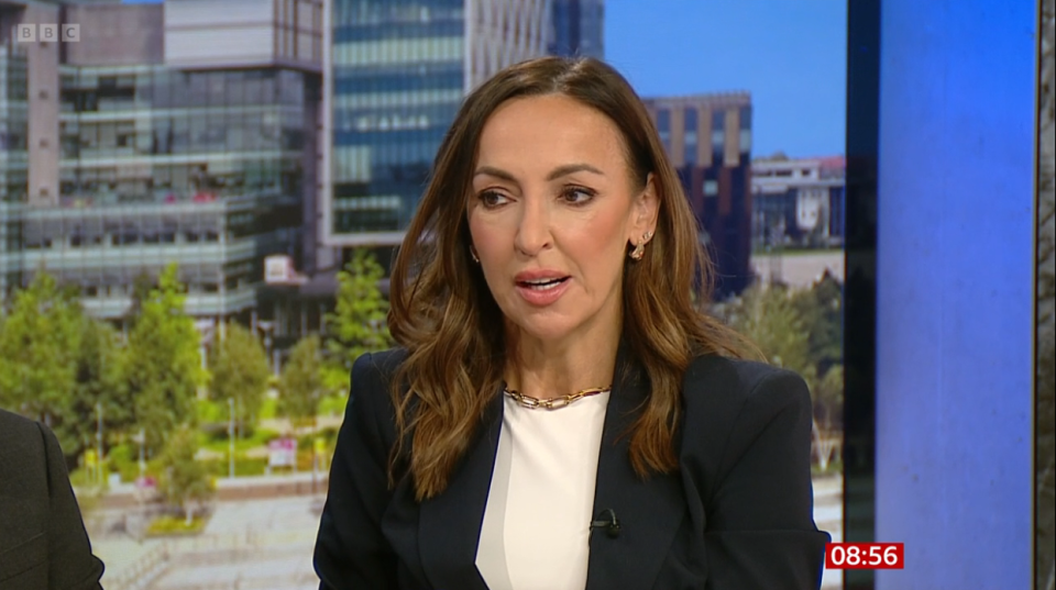 a woman in a suit is on a bbc show