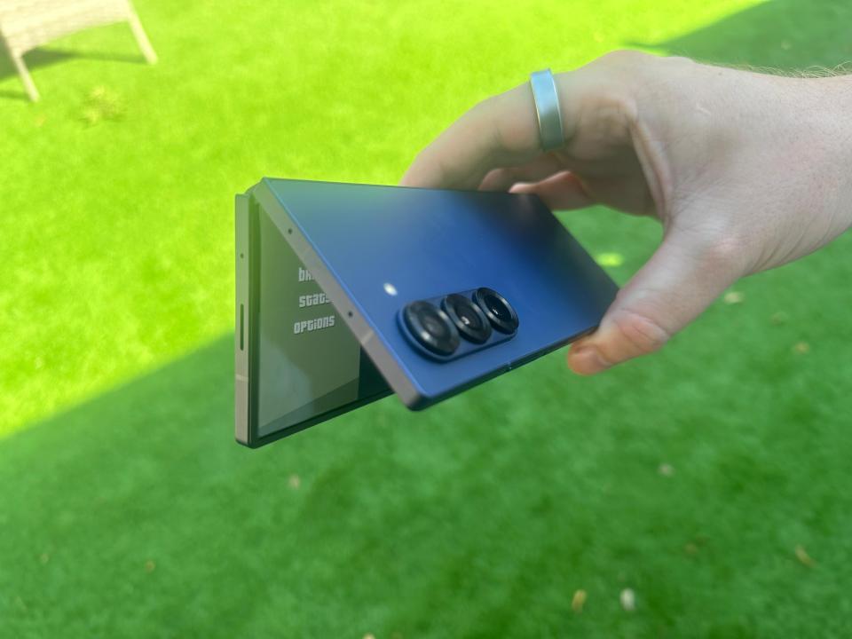 a person is holding a phone that has the word options on it