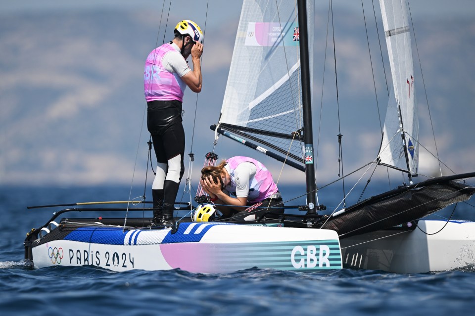two people on a boat that says gbr on the side