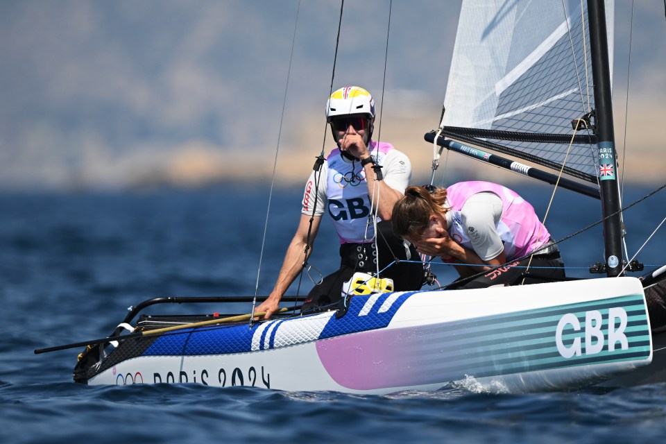 two people on a boat that says gbr on it