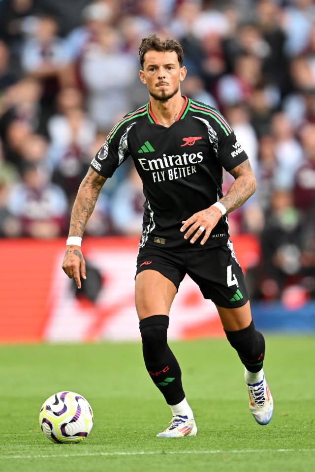 soccer player wearing a jersey that says emirates fly better