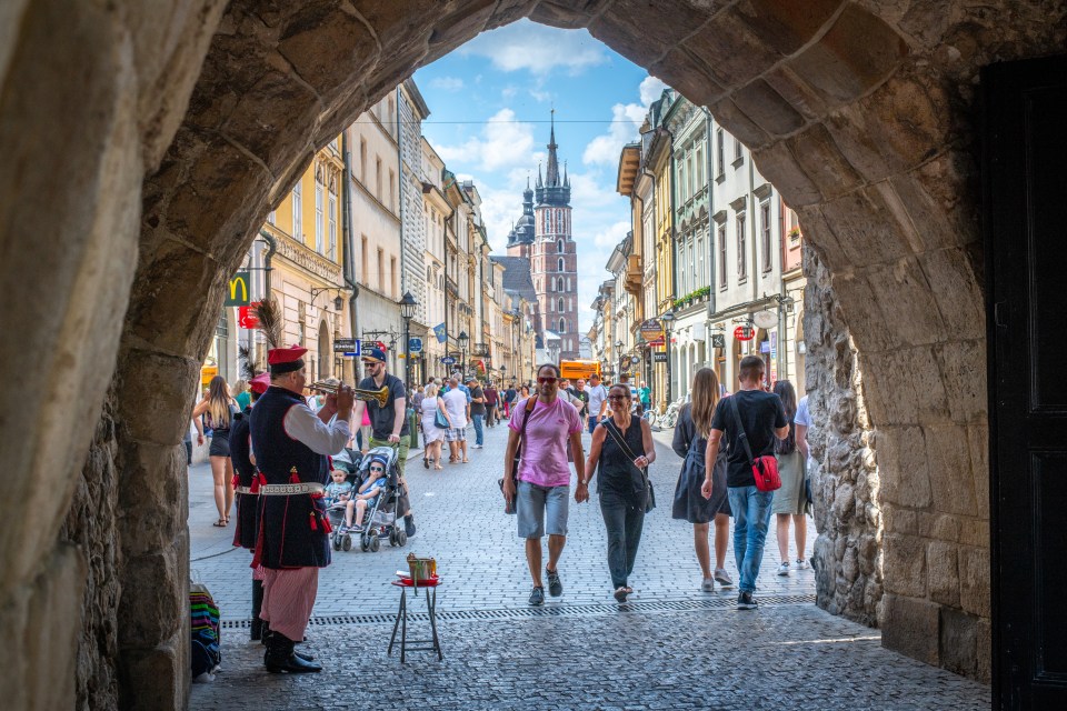 people walking down a street with a mcdonald 's sign in the background