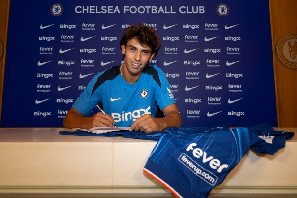 a man signing a chelsea football club jersey