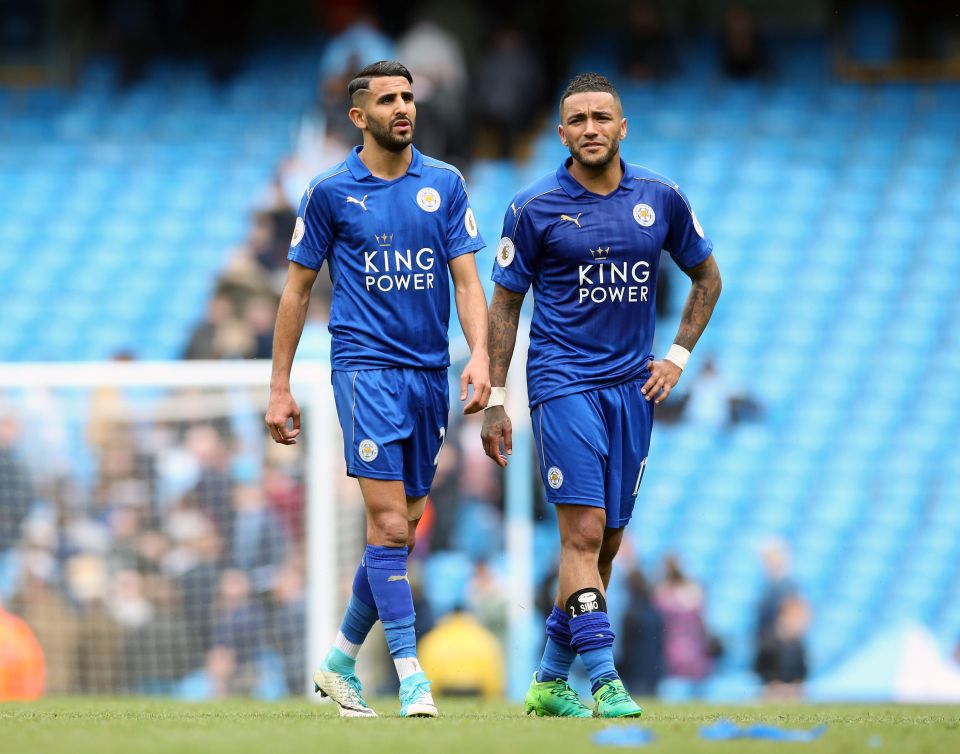 two soccer players wearing blue shirts that say king power