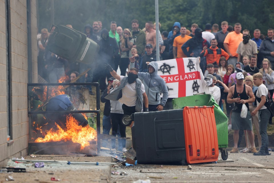 a group of people holding a flag that says england