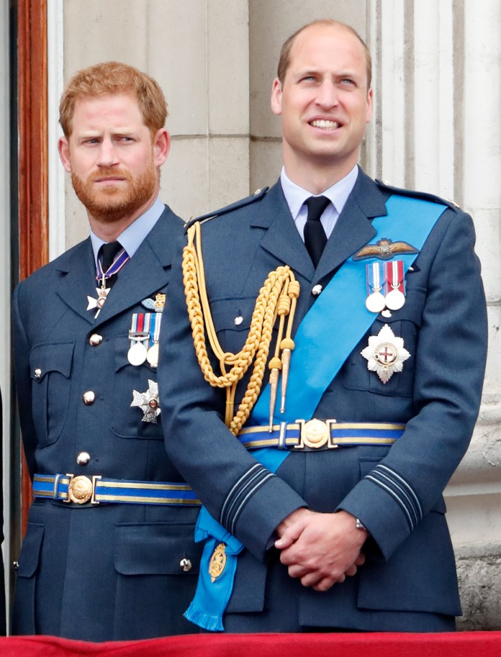 two men in military uniforms are standing next to each other