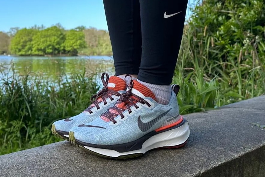 a person wearing a pair of nike running shoes