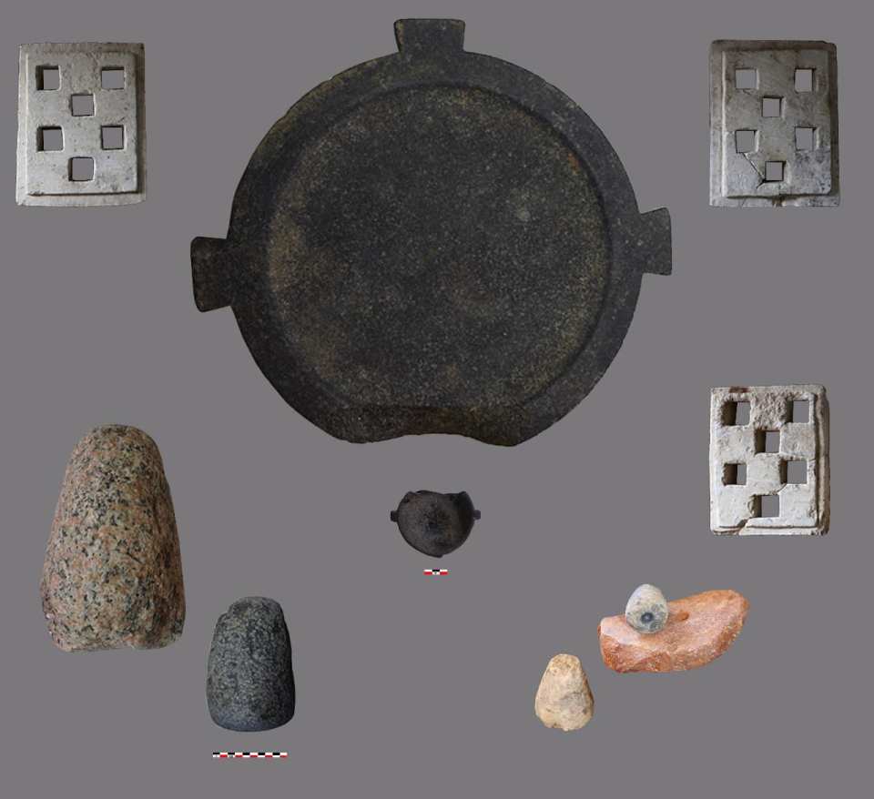 a group of rocks and a metal object on a gray background