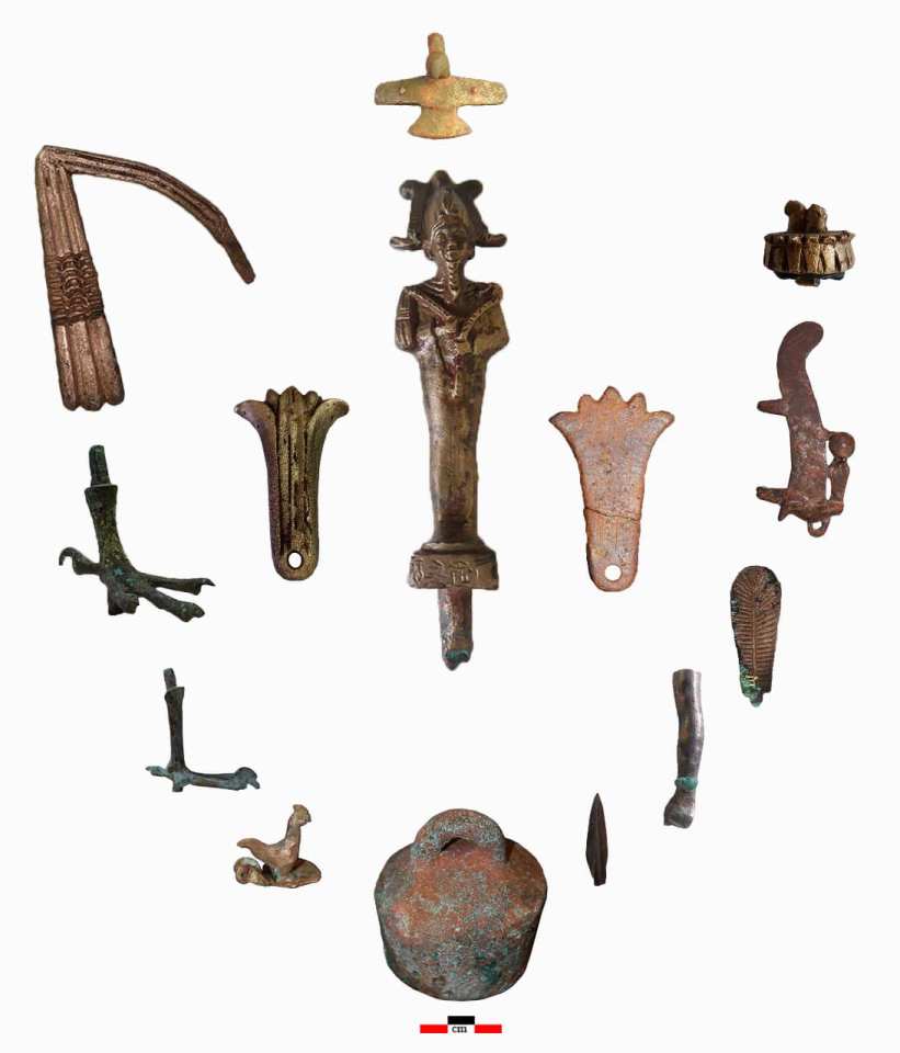 a collection of ancient artifacts including a statue of a man