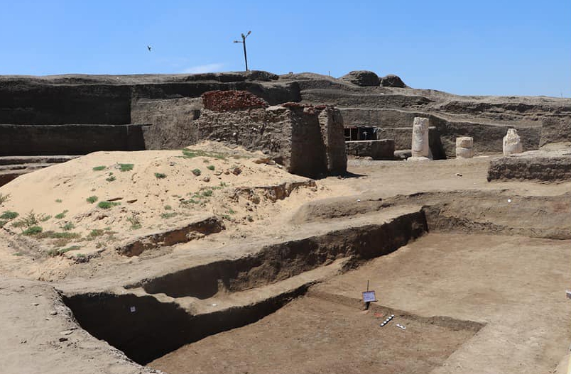 a dirt area with a sign that says ' archaeology ' on it