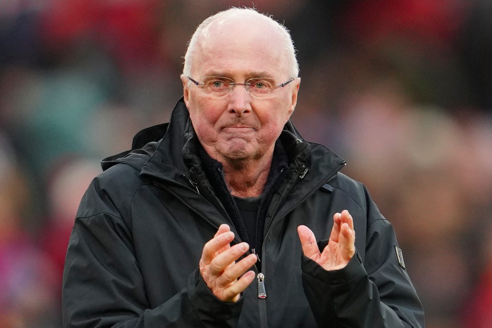 a man wearing glasses and a black jacket is clapping his hands
