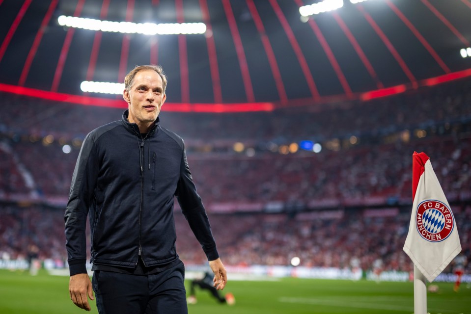 a man stands on a soccer field with a flag that says fc bayern munich