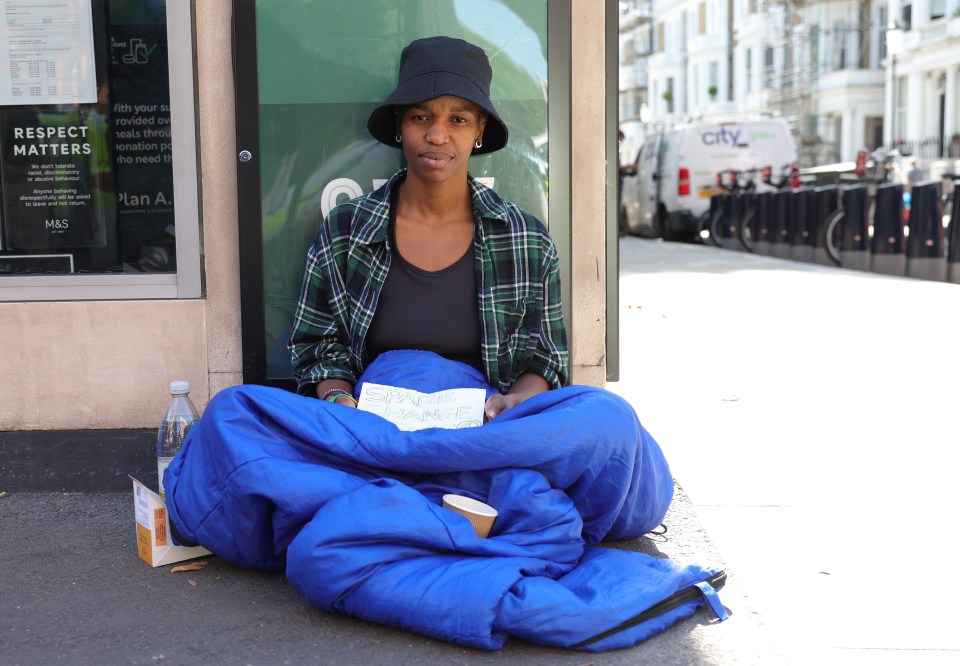 a woman sits on the sidewalk with a sign that says respect matters