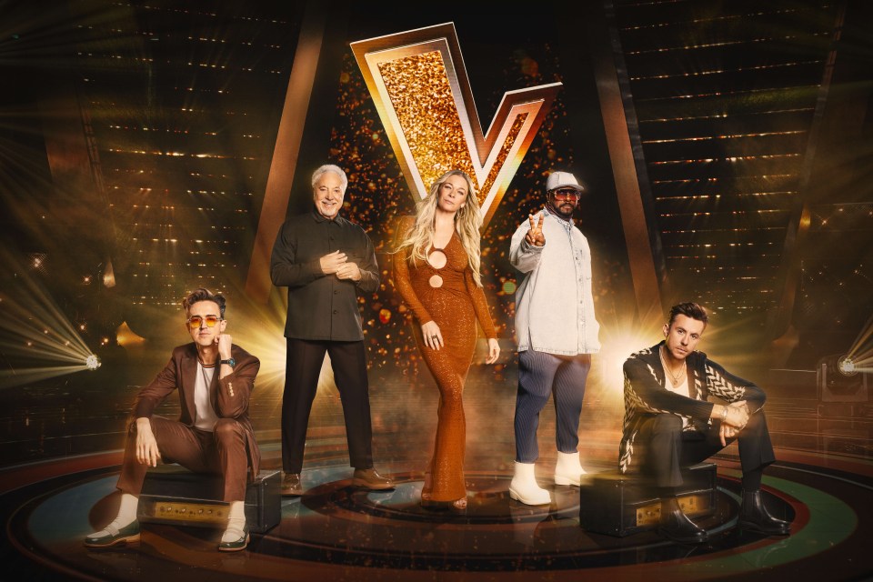 a group of people standing in front of a large v