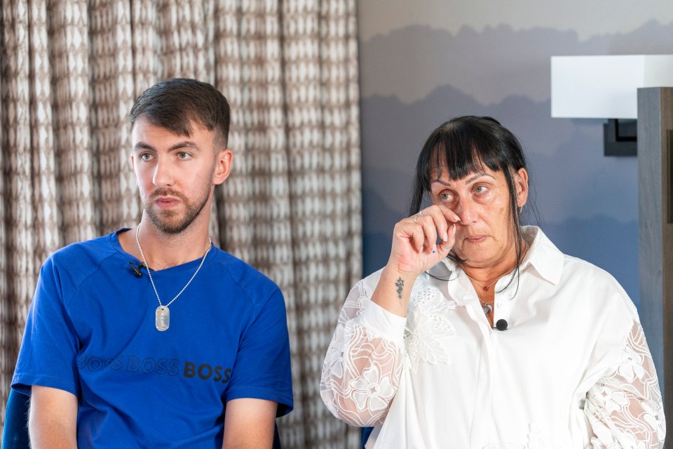 a man in a blue boss shirt sits next to a woman