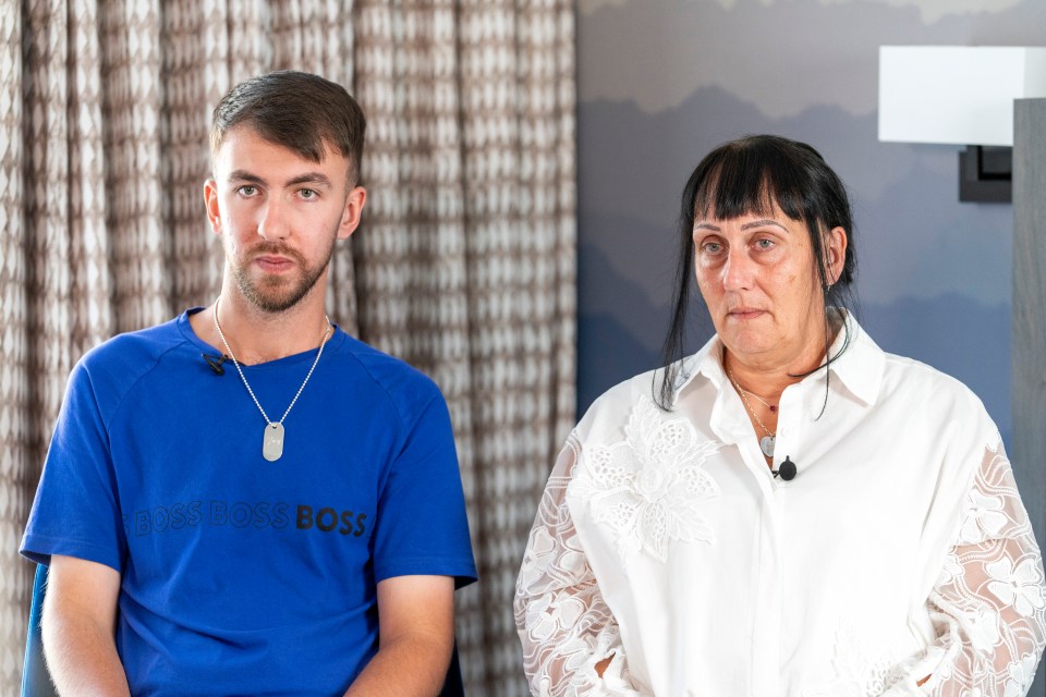 a man wearing a blue boss boss shirt sits next to a woman