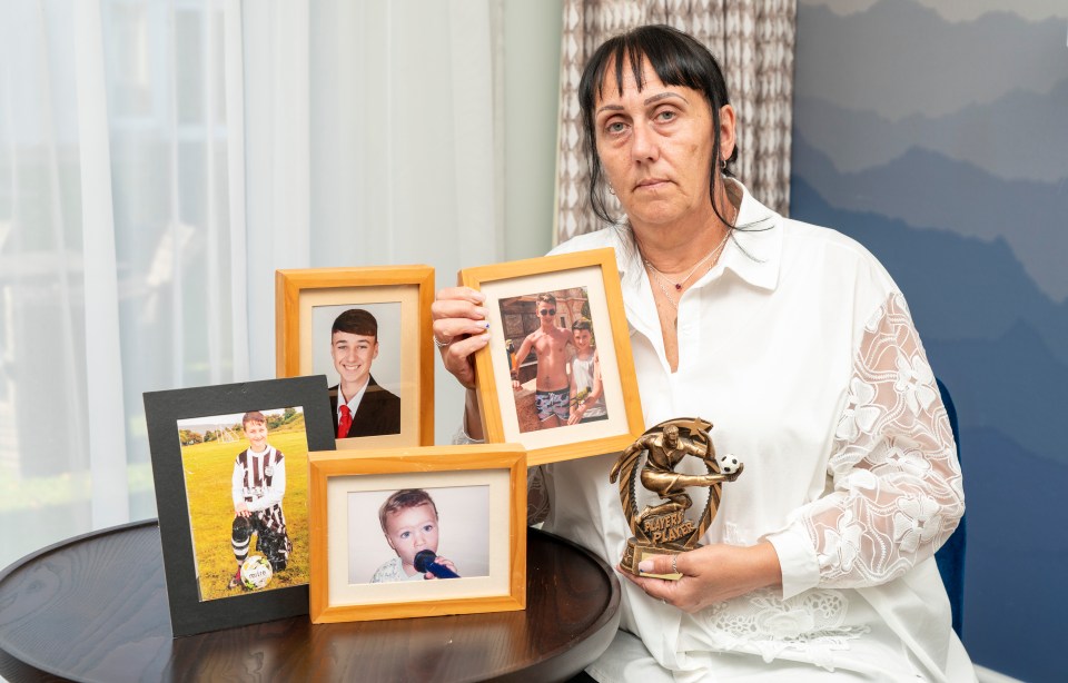 a woman is holding a trophy that says ' soccer ' on it