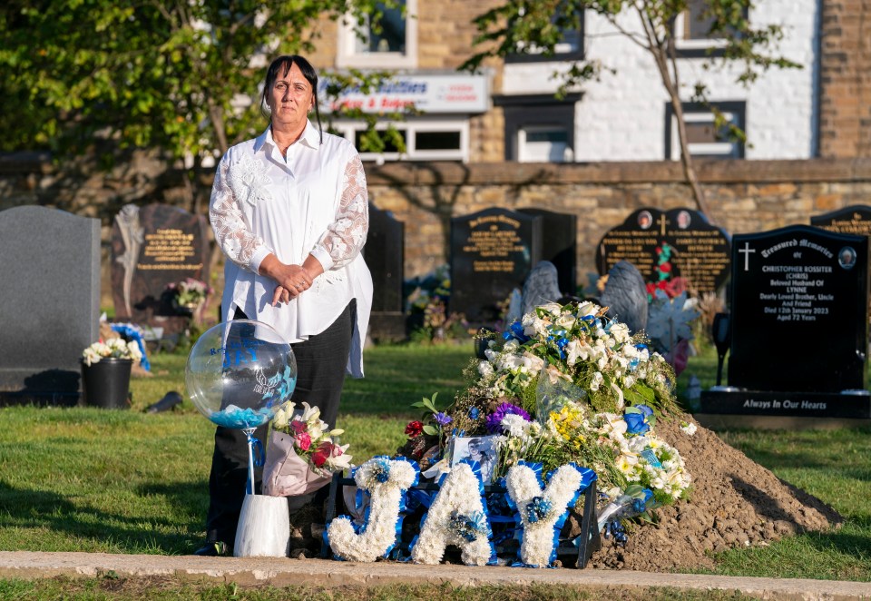 a woman stands in front of a grave with the name jay on it