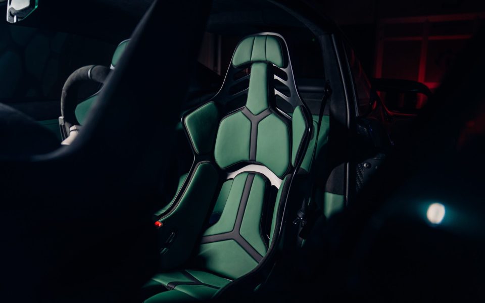 a green seat in a car with a black frame