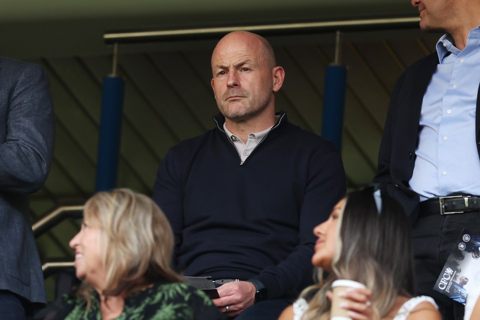 a man sitting in a stadium with a ticket that says crow on it