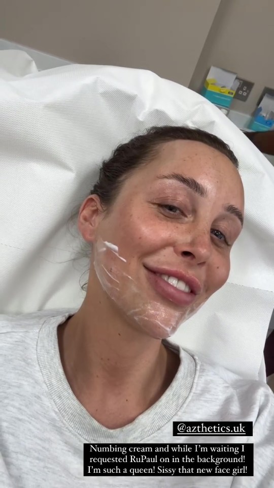 a woman is smiling while laying in a hospital bed