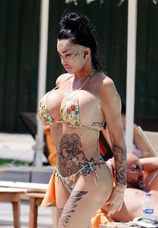 a woman in a bikini has a tattoo of a horse on her arm