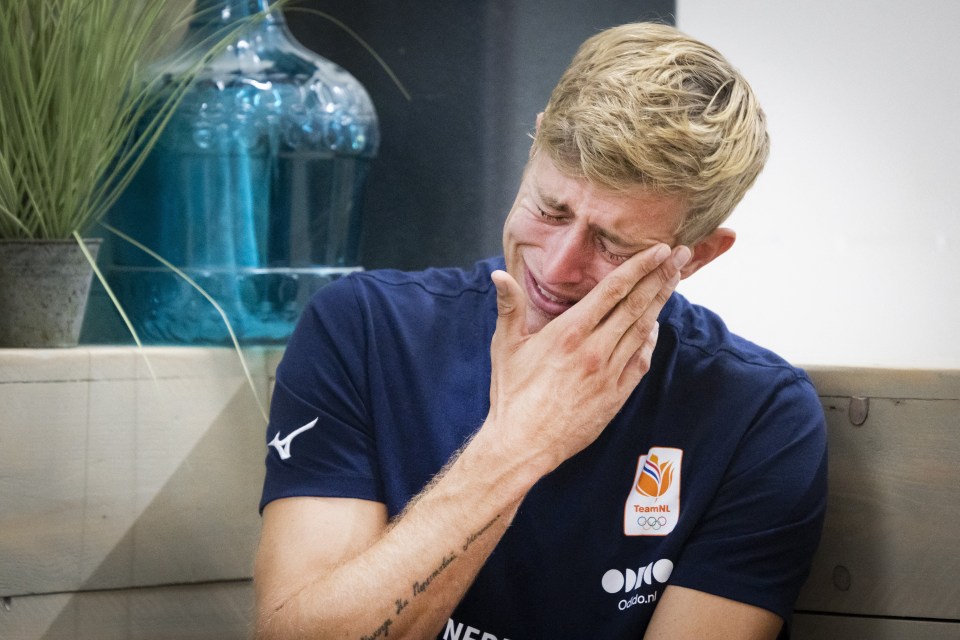a man wearing a shirt that says netherlands is crying