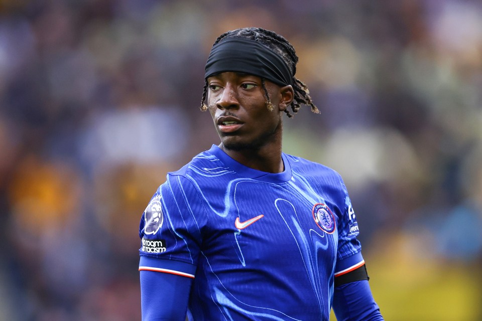 a soccer player wearing a headband and a blue shirt that says hyundai