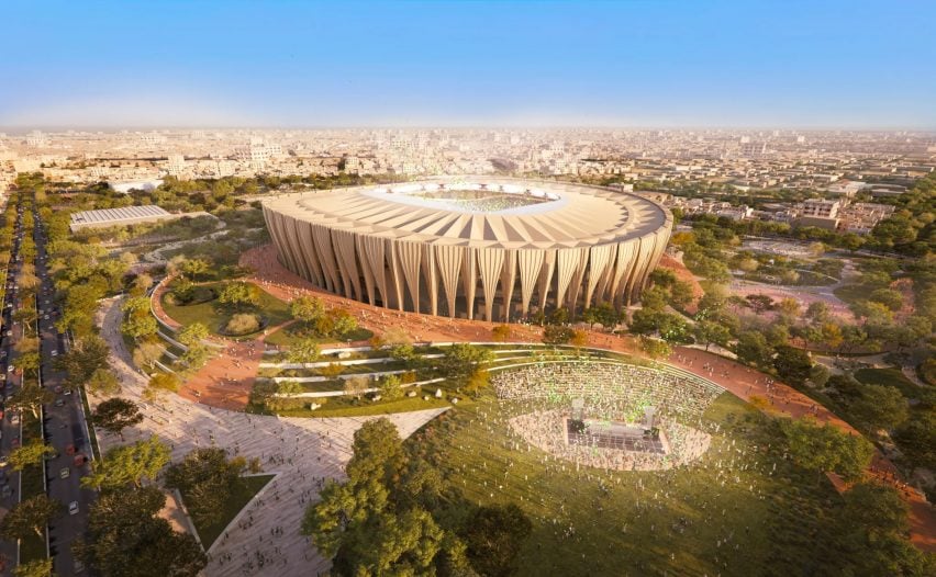 Aerial view of a futuristic World Cup stadium and surrounding park.