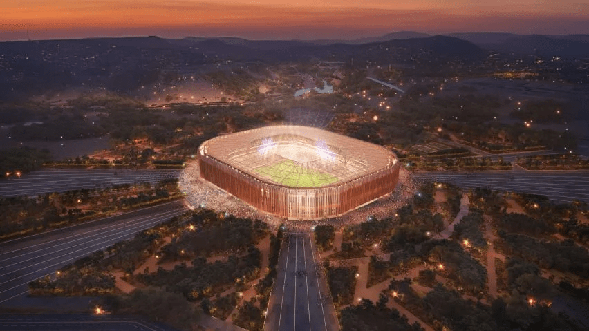 Aerial view of a futuristic stadium at night.