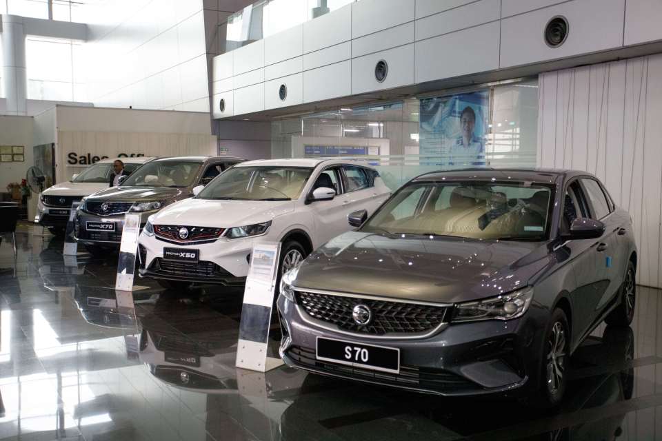 a row of cars are on display in a showroom with a sign that says s70
