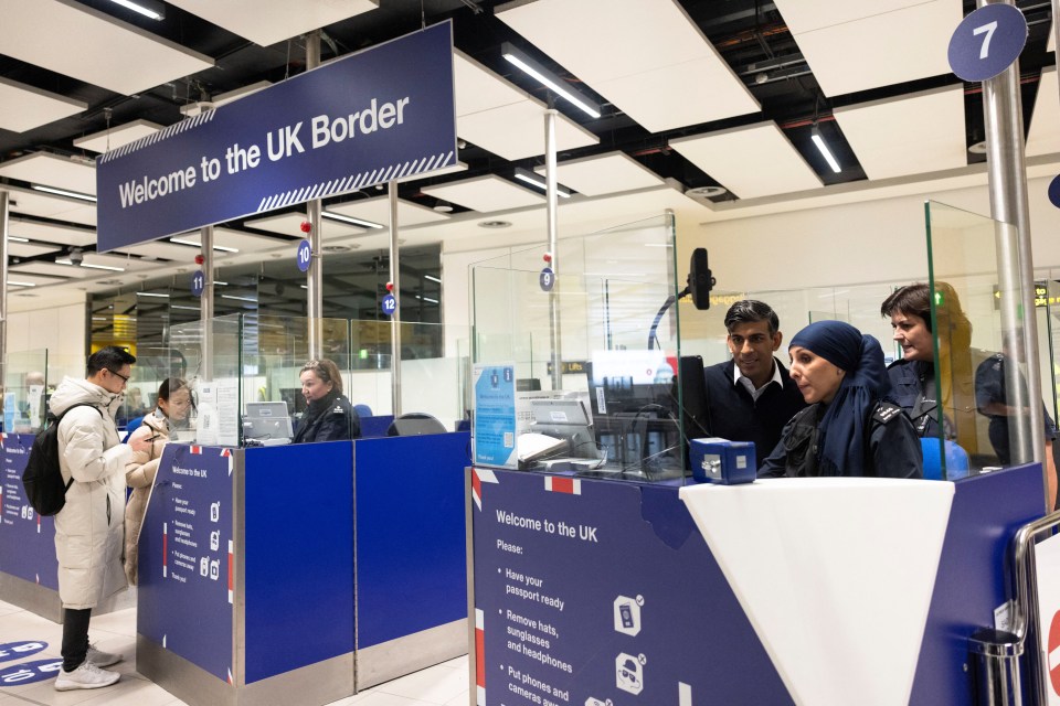 a welcome to the uk border sign hangs above a counter