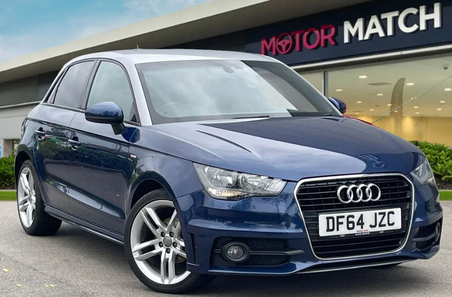 a blue audi is parked in front of a motor match store