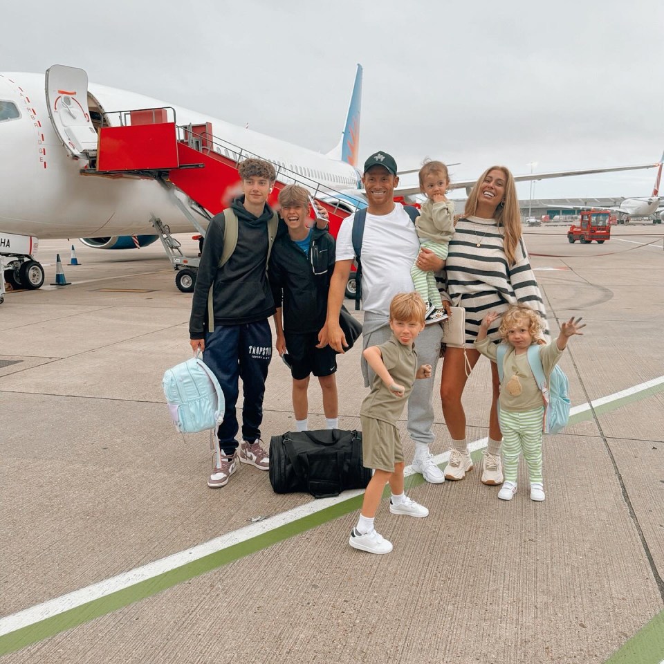 a family standing in front of an airplane with a bag that says jump on it