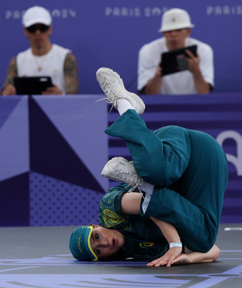 a person doing a handstand in front of a sign that says paris