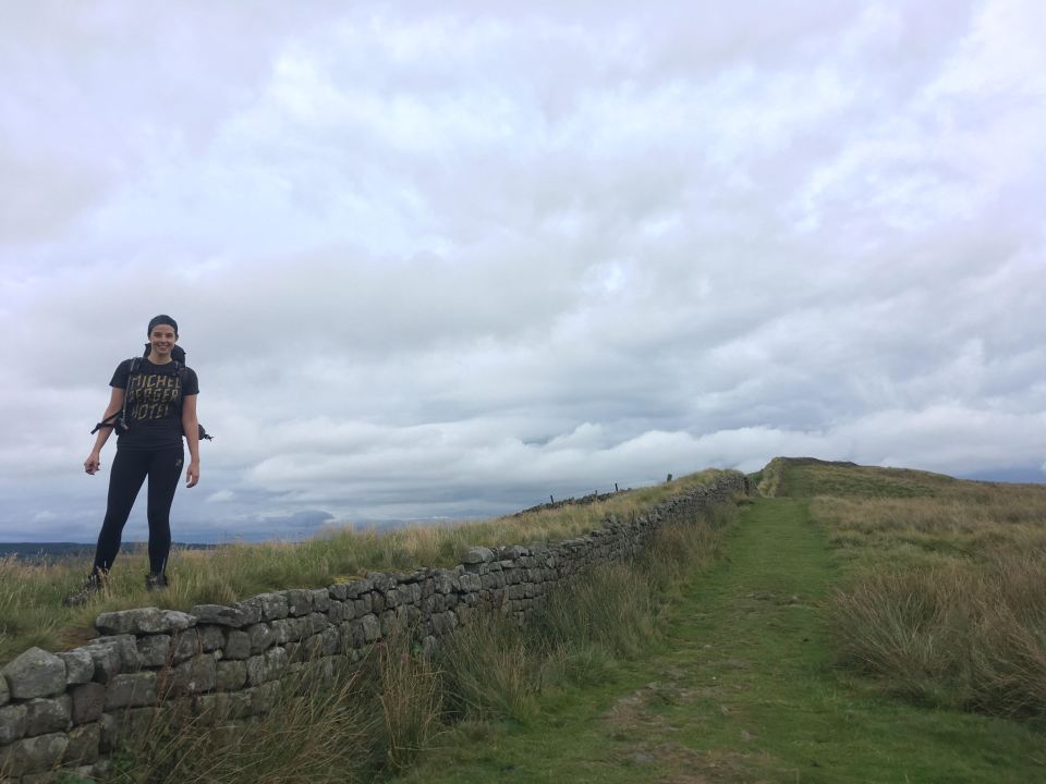 a woman standing on a hill wearing a t-shirt that says " choose your witch "