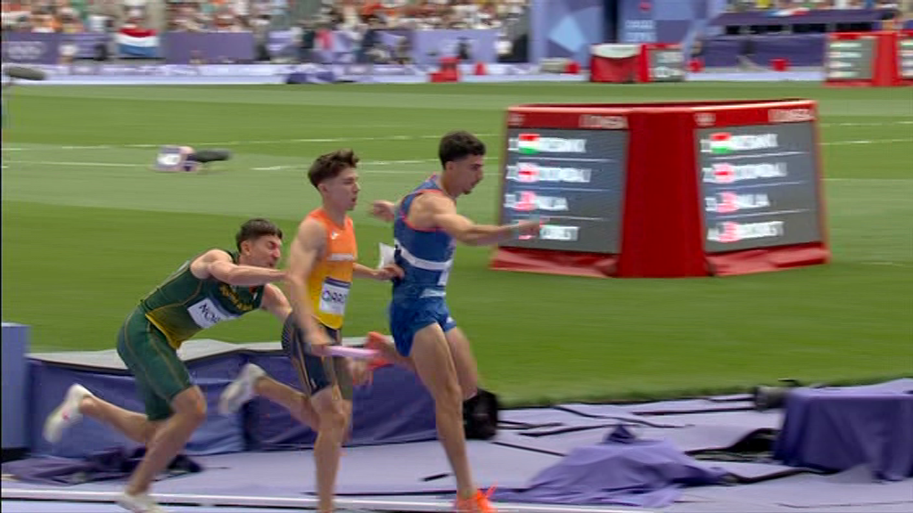 a group of athletes are running on a track and one of them has the name chris on his shorts