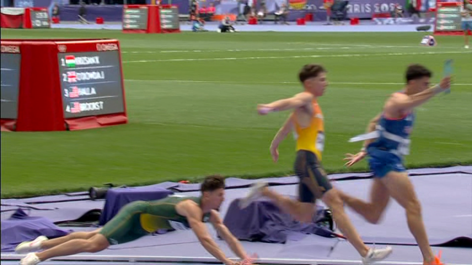 a group of men are running on a track with a scoreboard behind them that says omega