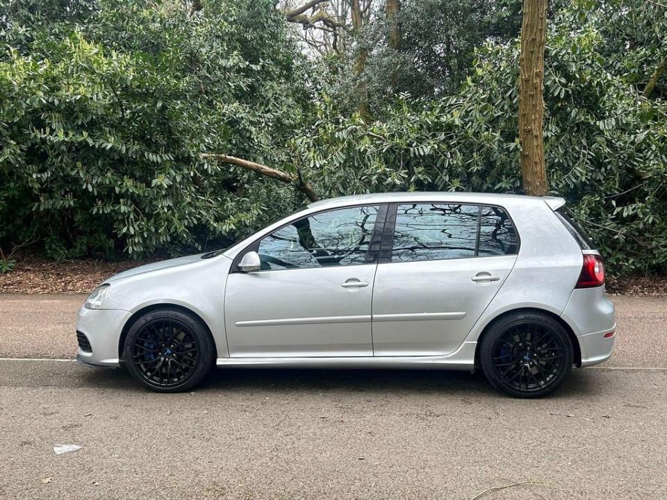 a silver car is parked on the side of the road
