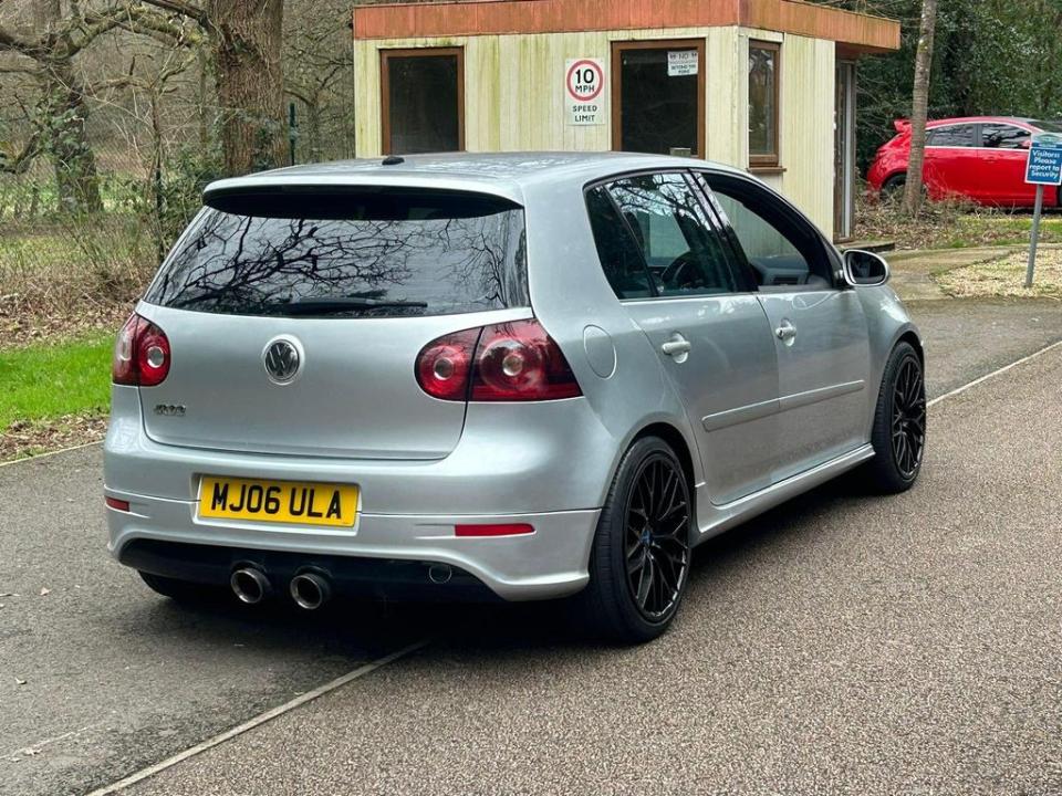 a silver car with a license plate that says mj06 ula