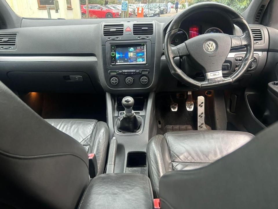 the interior of a volkswagen with a steering wheel and dashboard